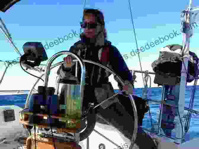 Janette Yoke Standing At The Helm Of Her Sailboat, Surrounded By The Vast Ocean Sailing Across The Sea Janette Yoke